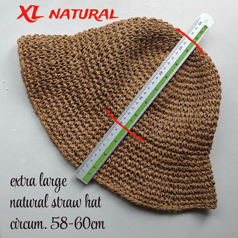 May include: A white ceramic mug with a black handle and the text "But First, Coffee" in a black, handwritten-style font. The mug is on a white surface.