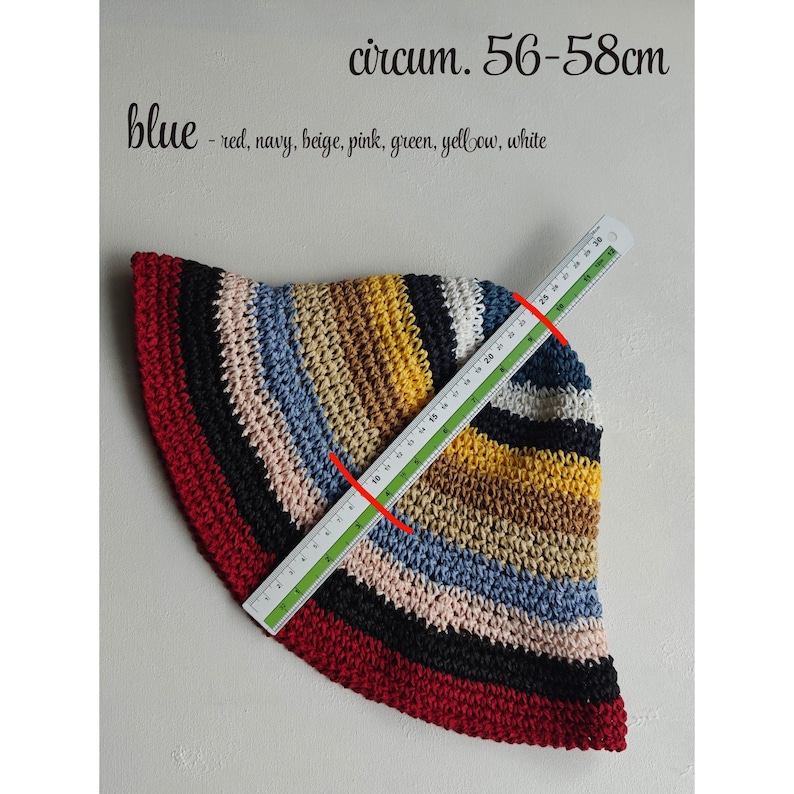 May include: A multi-colored, crocheted hat with a brim, featuring stripes of red, black, beige, pink, blue, yellow, and white. The hat's circumference is 22-23 inches. The text on the image says "blue - red, navy, beige, pink, green, yellow, white".