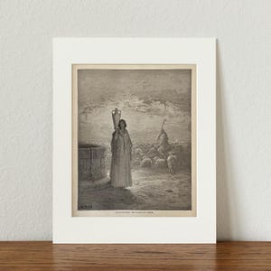 May include: A black and white engraving of a woman carrying a large jug on her shoulder. She is walking towards a well in the distance. There are sheep in the background and a man sitting on a rock. The engraving is titled "Jacob tending the flocks of Laban."