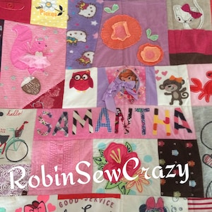 May include: A pink and white patchwork quilt with the name Samantha written in pink and blue letters. The quilt is made from various pieces of fabric with different patterns and designs, including a squirrel, a flower, a cat, and a princess. The quilt also includes the text "RobinSewCrazy" and "Long Island Diner".