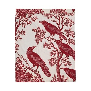 May include: Red and white fabric with a repeating pattern of crows perched on branches. The crows and branches are in a red colour, while the background is white.