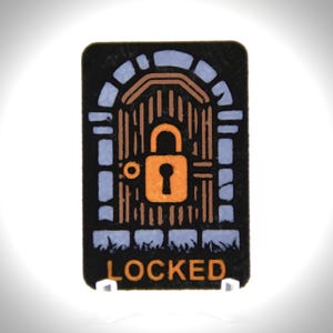 May include: A rectangular black sign with a stylized image of a locked gate and the word "LOCKED" in orange. The gate is brown with a gold padlock, set against a blue and white stone archway.
