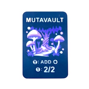 May include: A rectangular, dark blue card with the word "MUTAVAULT" at the top. The card features a purple and white illustration of mushrooms and a tree. Below the illustration are game instructions: "T: ADD O" and "1: 2/2".