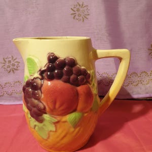 Vintage barbotine pitcher with numbered fruit decoration