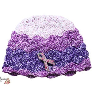 May include: Purple, white, and lavender crocheted hat with a sparkly pink ribbon accent.  The hat has a scalloped edge.