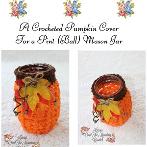 May include: A crocheted orange pumpkin cover for a pint-sized mason jar. The cover has brown trim and is decorated with fall leaves and vines. The text "Krissys Over The Mountain Crochet" is visible on the label.