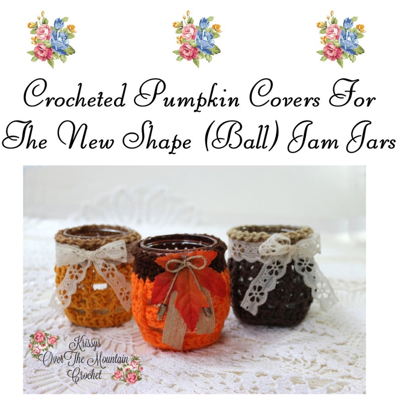 May include: Three crocheted pumpkin covers for jam jars. The covers are in orange, brown, and tan with lace trim and ribbon accents. The jars are sitting on a white lace tablecloth.