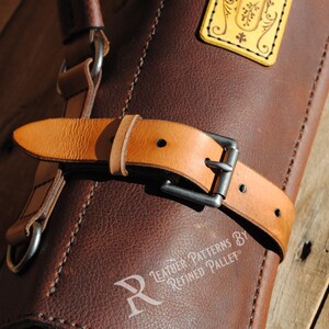 May include: Close-up of a brown leather bag with a light brown leather strap and a silver buckle. The bag has a decorative yellow tag. The text "Leather Patterns By Refined Pallet" is visible.