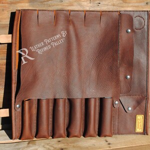 May include: A brown leather tool roll with multiple pockets and a flap closure. The roll features a series of vertical pockets for holding tools, and a strap with a buckle to secure the roll. The text "Leather Patterns by Refined Pallet" is visible.