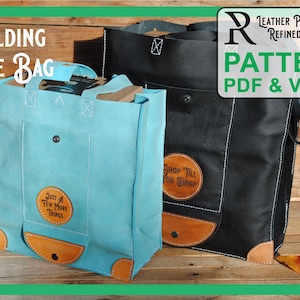May include: Two leather tote bags, one blue and one black, with contrasting brown leather accents. The blue bag has the text "Just a Few More Things" on it, and the black bag has the text "Shop Till You Drop".