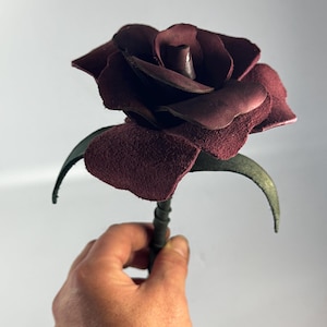 May include: A set of three ceramic mugs with a speckled, matte finish. The mugs are in shades of cream, light gray, and dark gray. Each mug has a simple, modern design and a rounded handle.