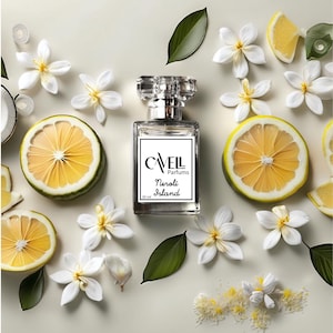 May include: A clear glass bottle of perfume with a silver cap. The bottle is labelled "Caveil Parfums Nerolli Island 30 ml". The bottle is surrounded by white flowers and lemon slices on a white background.