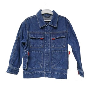 May include: A blue denim jacket with red accents and multiple pockets. The jacket has a button closure and long sleeves.