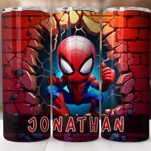 May include: A red and blue cartoon Spider-Man character breaks through a brick wall. The tumbler has a personalized name, "JONATHAN", printed on the bottom.