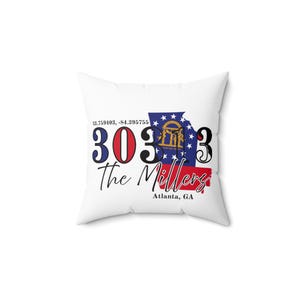 May include: White square cushion with the text "303 The Millers". The design incorporates a blue and red graphic of the Georgia state flag, with "Atlanta, GA" written below. Coordinates are also included.