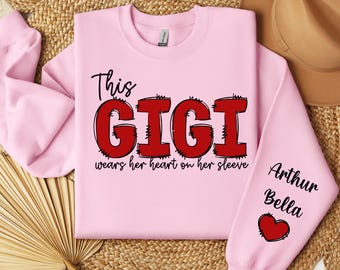 Custom This Gigi Wears Her Heart On Her Sleeve, Personalized Gigi Valentine Sweatshirt, Valentine Gigi Sweatshirt, Gigi Heart Sweatshirt