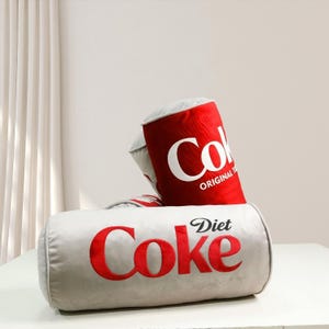 a diet coke can sitting on top of a bag