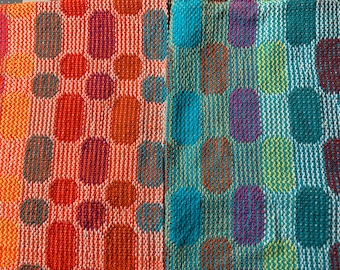 May include: Two fabric swatches with a geometric pattern of colourful circles. The fabric on the left is orange and white, while the fabric on the right is blue and white.