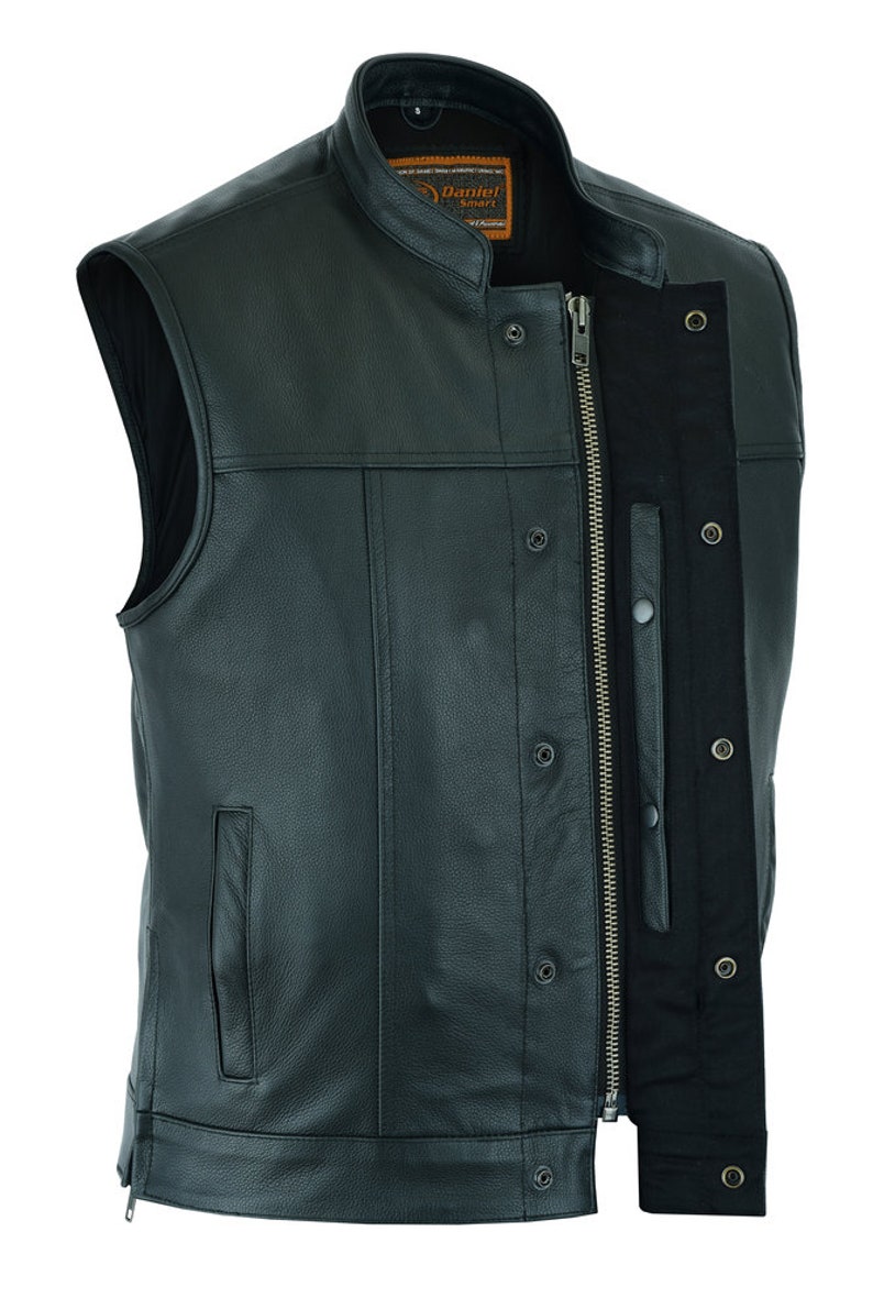 May include: A black leather motorcycle vest with a zipper closure and snap buttons. The vest has a stand-up collar and two pockets on the front.