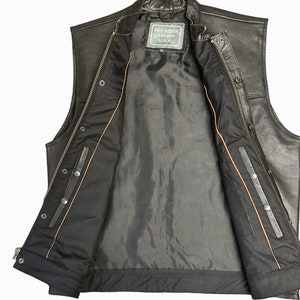 May include: Black leather vest with a zipper closure and snap buttons. The vest has a brown lining and a label that reads "Pro Rider Leathers U.S.A."
