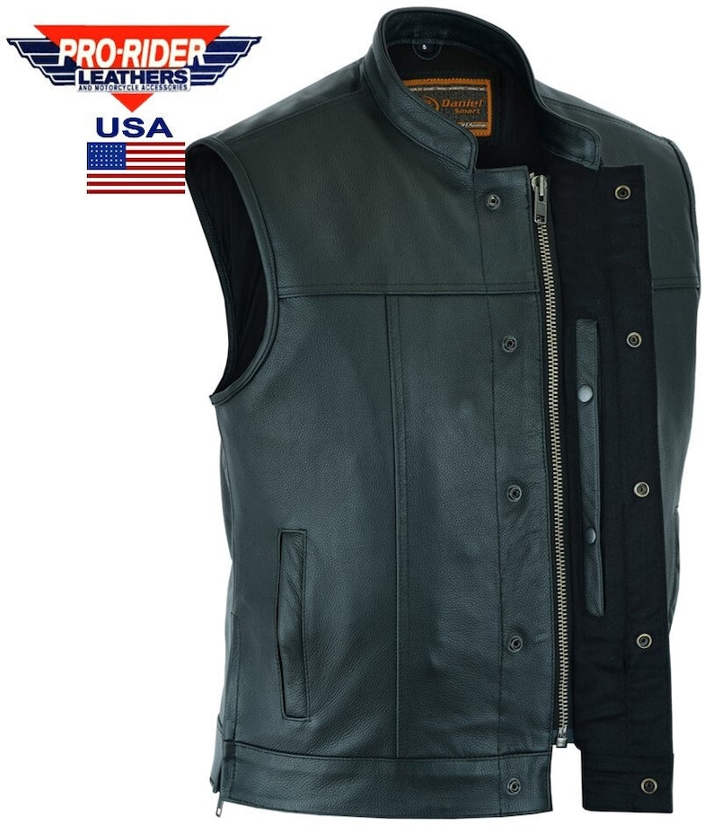 May include: Black leather motorcycle vest with a zipper closure and snap button accents. The vest has a stand-up collar and two pockets. The vest is made in the USA.