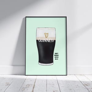 May include: Framed print of a pint of Guinness. The black stout has a creamy white head, with the Guinness logo above. The text "Don't worry, life is all G" is below the pint. The print is in a black frame.