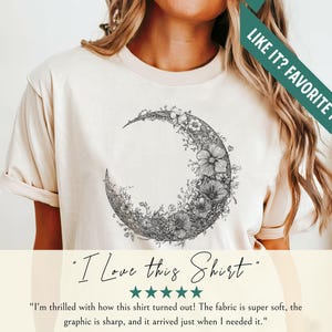 Black and white floral crescent moon design on a minimalist boho t shirt, showcasing delicate nature inspired linework that forms an elegant lunar shape perfect for astrology lovers and those seeking celestial style.