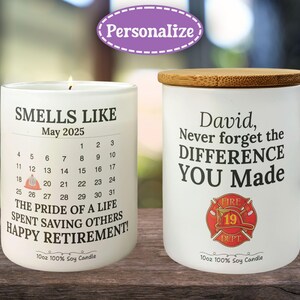 May include: Two white soy candles with wooden lids. One candle reads "Smells Like May 2025" with a calendar and retirement message. The other candle says "David, Never forget the DIFFERENCE YOU Made" with a fire department emblem.