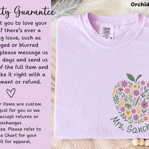 May include: Orchid-colored t-shirt featuring a floral apple design with pencils and flowers, and the name "Mrs. Sanchez" in green script. The shirt has a Comfort Colors tag and text that says "Quality Guarantee".