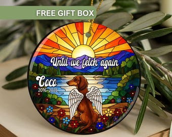 May include: A round, stained-glass style ornament featuring a dachshund with angel wings, set against a landscape with a lake, mountains, and a sunset. The text "Until we fetch again" and the name "Coco" are displayed.