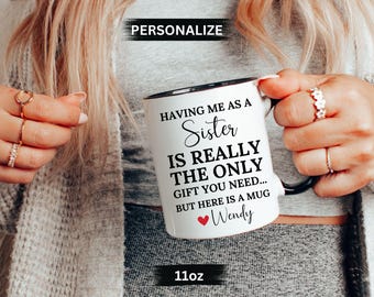 May include: White ceramic mug with a black rim and handle. The mug has black text that reads "Having me as a Sister is really the only gift you need... But here is a mug Wendy". There is a small red heart next to the name Wendy. The mug is 11oz.