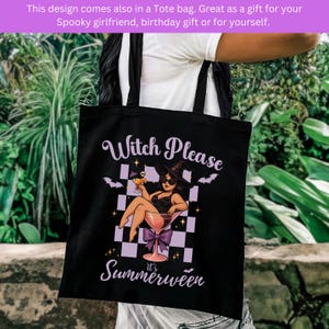 May include: Black tote bag with a witch-themed design. The graphic shows a witch in a martini glass, bats, and a checkered pattern, with the text "Witch Please, it's Summerween." The bag has black handles and is made of a durable material.