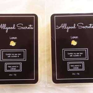 May include: Two lemon-scented soy wax bars in clear packaging. Each bar has a black label with white text that reads "Allgood Secrets" and "Lemon". The label also states "Scented soy wax bars with essential oil" and "Hand poured in Colorado".