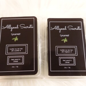 May include: Two rectangular wax melt bars in clear plastic packaging. Each bar has a black label with white text that reads "Allgood Secrets Spearmint." The labels also state "Scented soy wax bars" and "Hand poured in Colorado."
