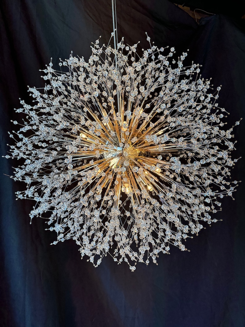 Picture of sputnik chandelier, gold color, on a black background