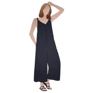 May include: A woman wearing a dark blue jumpsuit with a V-neck and wide legs. She is wearing sandals and has her hand on her head.