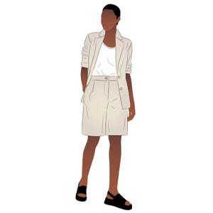 May include: A person wearing a beige blazer and shorts with a white t-shirt and black sandals.