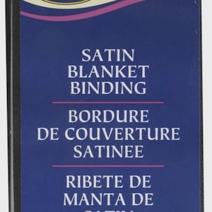 May include: A black package of Wrights satin blanket binding. The label is white with a blue and pink design. Text includes "SATIN BLANKET BINDING", "4.75 yd/4.34 m", and the product code "PC794".