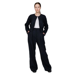 May include: A woman wearing a dark blue suit with a cropped jacket and wide-leg pants.