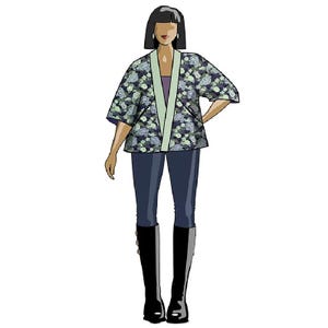 May include: A woman wearing a floral print kimono jacket with a light green collar and a dark green under layer. She is wearing dark blue jeans and black boots.