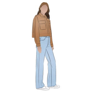 May include: A woman wearing a brown cropped jacket and light blue jeans. She is standing with her hands at her sides.