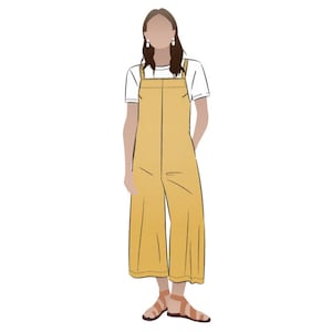 May include: A woman wearing a white t-shirt and yellow overalls with a wide leg. She is wearing sandals and has her hair down.