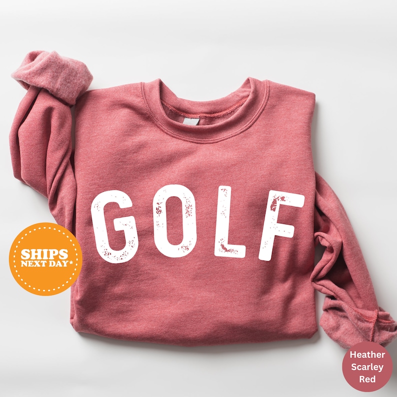 a red shirt with the word golf printed on it