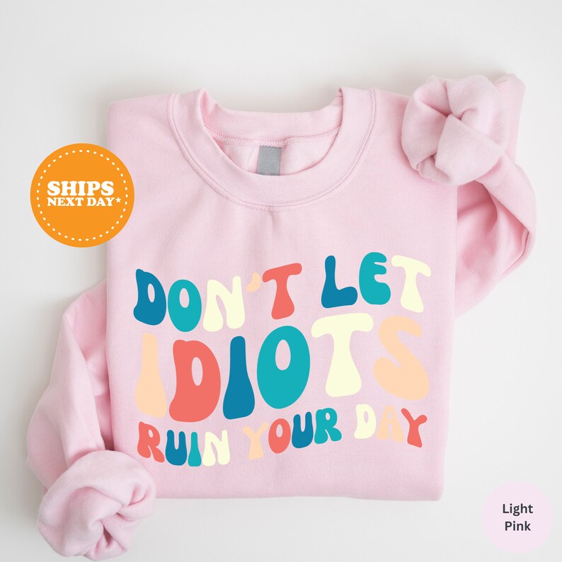 a pink shirt that says don't let idiots run your day