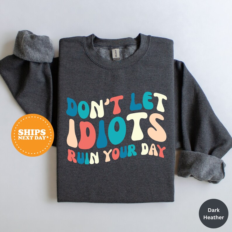 a t - shirt that says don't let idiots run your day