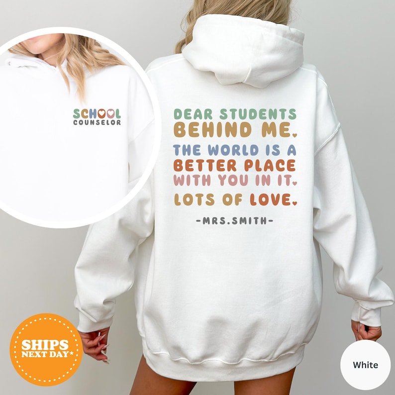 a woman wearing a white sweatshirt with the words dear students behind her