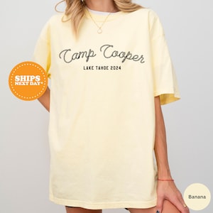 a woman wearing a yellow camp cooper t - shirt