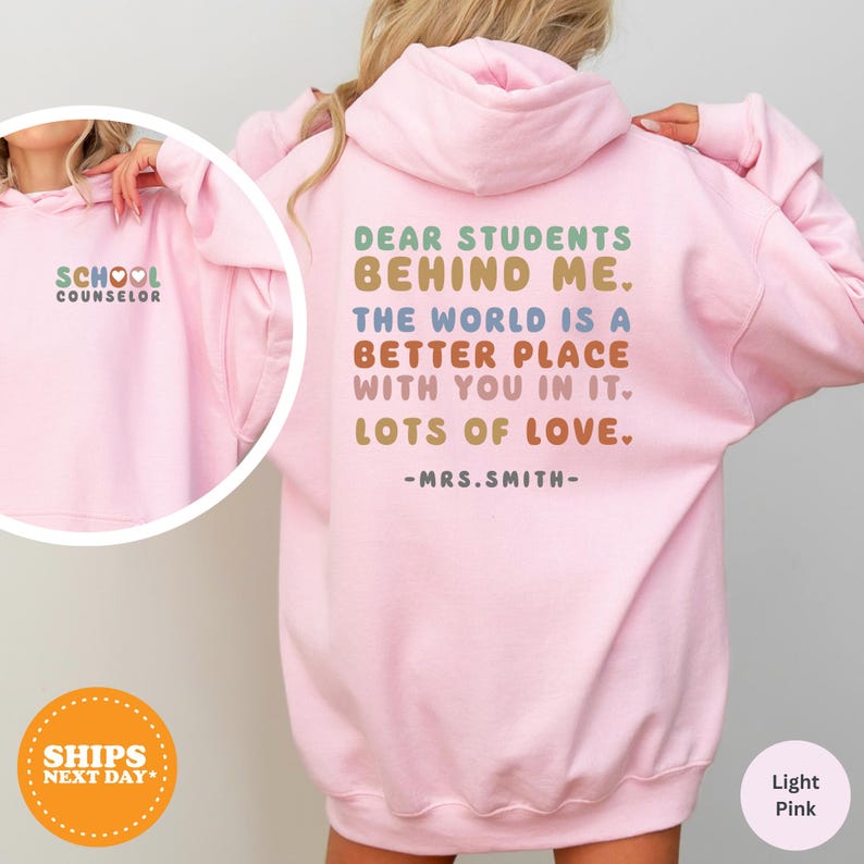 a girl wearing a pink sweatshirt with the words dear students behind her