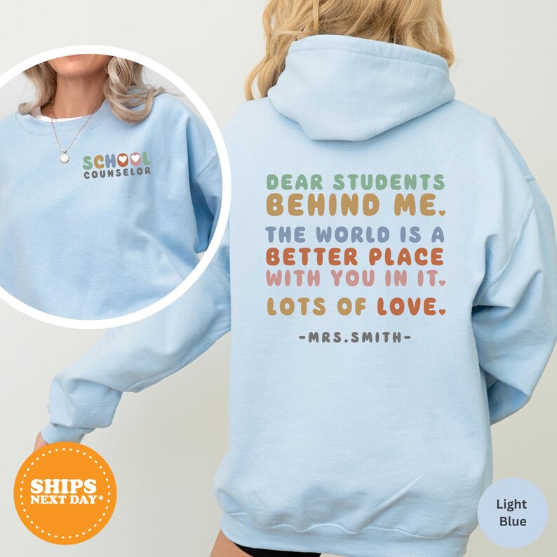 a woman wearing a light blue sweatshirt with the words dear students behind her