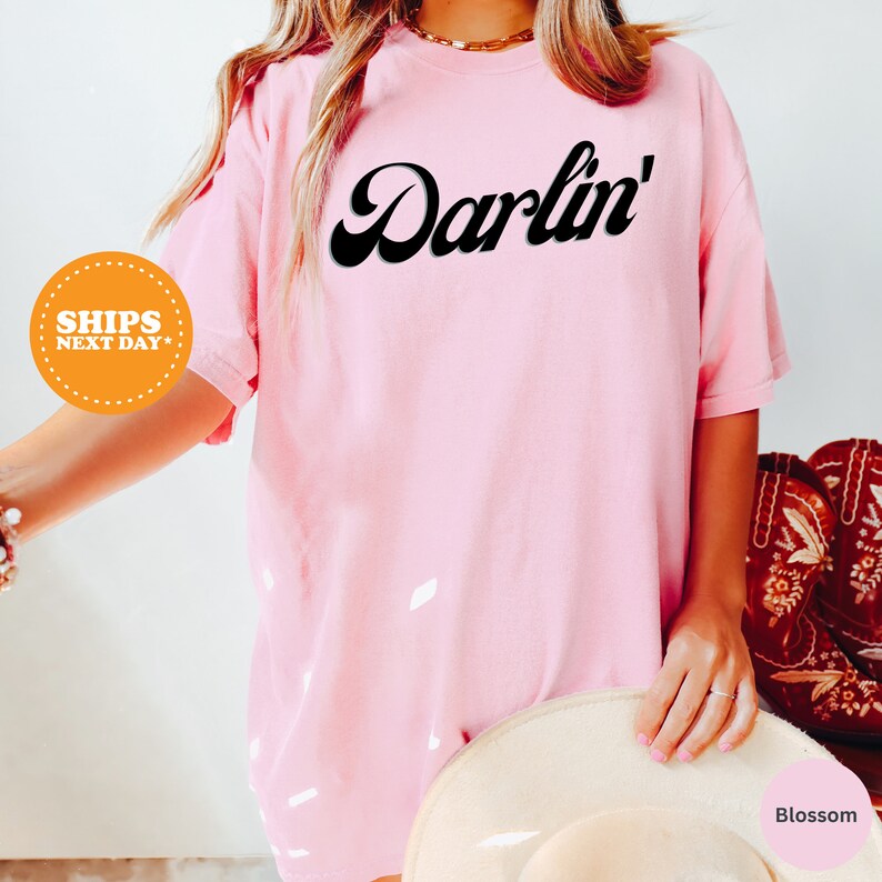 a woman wearing a pink shirt and hat